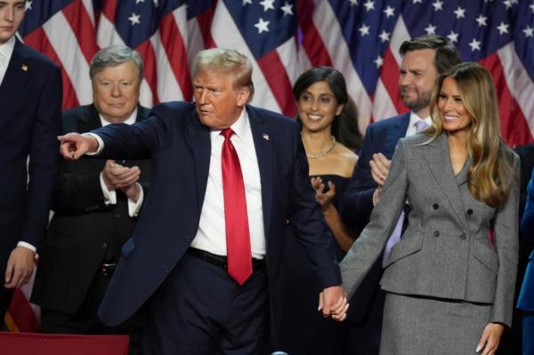 Republican Presidential nominee former President Do<em></em>nald Trump holds hands with former first lady Melania Trump after speaking to supporters at the Palm Beach County Co<em></em>nvention Center during an election night watch party, Wednesday, Nov. 6, 2024, in West Palm Beach, Fla. (AP Photo/Lynne Sladky)