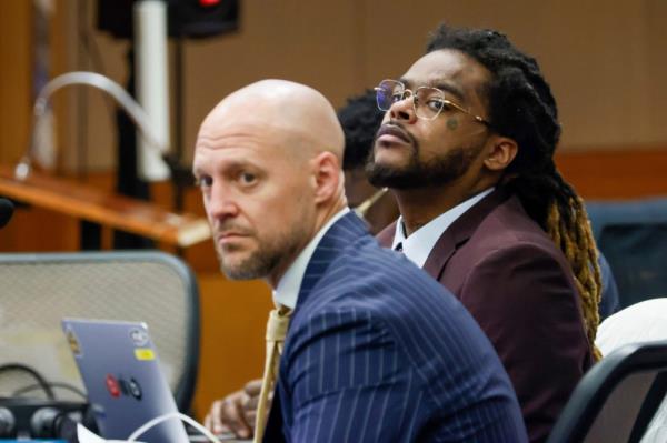 Shannon Stillwell and attorney Max Schardt sitting in Fulton County Courthouse, looking at prosecutors during the Young Thug trial, Atlanta, 2024