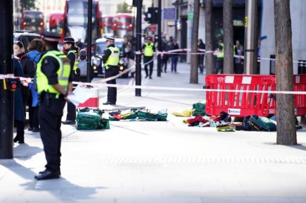 File photo dated 06/10/22 of police officers at the scene after three people have been taken to hospital following reports of stabbings at Bishopsgate in London. Louis Parkinson, 26, and Tyrone Dean, 24, were sentenced to twelve years each after being found guilty for their part in a robbery and knife attack in the City of Lo<em></em>ndon when a mobile phone robbery spree was thwarted. Issue date: Thursday August 10, 2023. PA Photo. See PA story COURTS Bishopsgate. Photo credit should read: James Manning/PA Wire