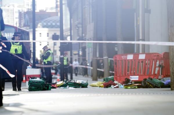 File photo dated 06/10/22 of police officers at the scene after three people have been taken to hospital following reports of stabbings at Bishopsgate in London. Louis Parkinson, 26, and Tyrone Dean, 24, were sentenced to twelve years each after being found guilty for their part in a robbery and knife attack in the City of Lo<em></em>ndon when a mobile phone robbery spree was thwarted. Issue date: Thursday August 10, 2023. PA Photo. See PA story COURTS Bishopsgate. Photo credit should read: James Manning/PA Wire