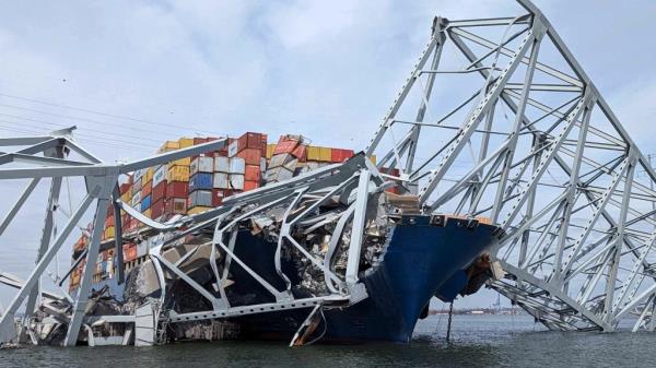 Part of the collapsed Francis Scott Key Bridge suspended on the co<em></em>ntainer ship Dali in Baltimore, Maryland