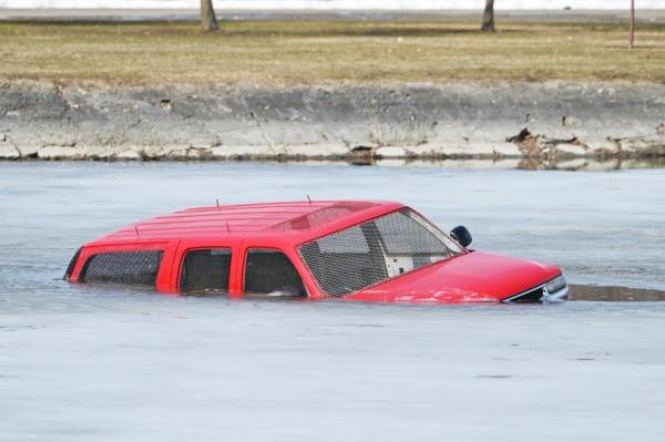 A red car submerged in water