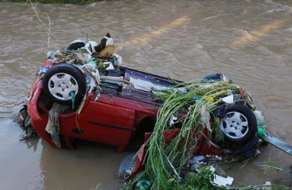 Overturned car submerged in a river due to flash floods in Taboao da Serra district, Sao Paulo, Brazil.